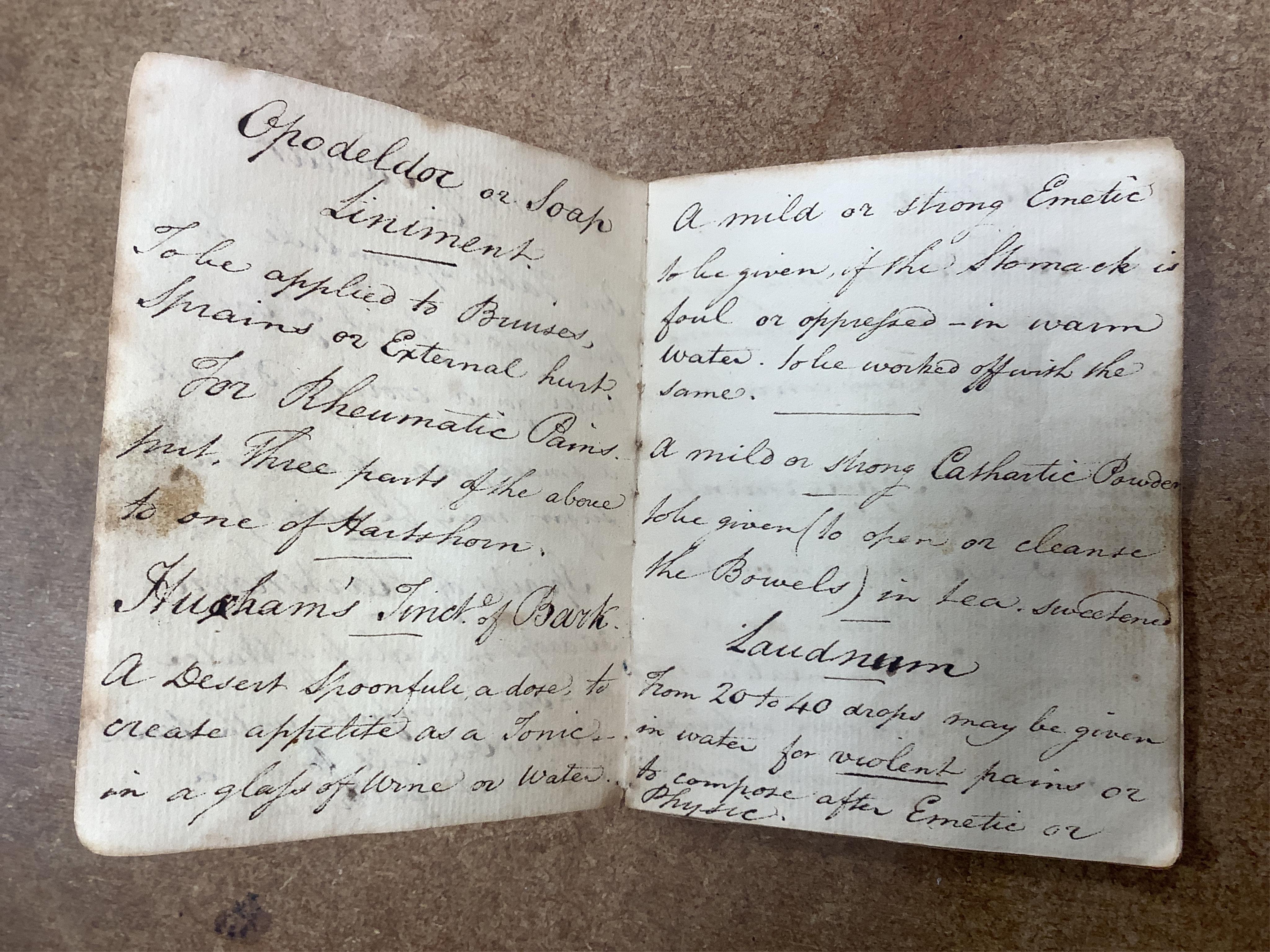 A 19th century mahogany apothecary cabinet, interior with fitting compartments containing twenty-one glass bottles, most with stoppers, five drawers with ivory knobs containing a miniature pestle and water, mixing glasse